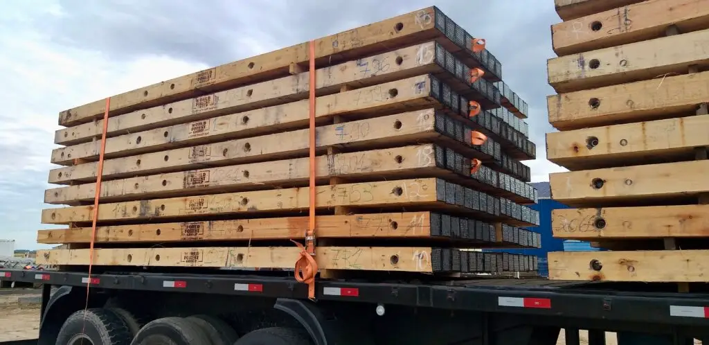 Loaded truck transporting Eucalyptus timber mats from central inventory to project site reducing freight costs